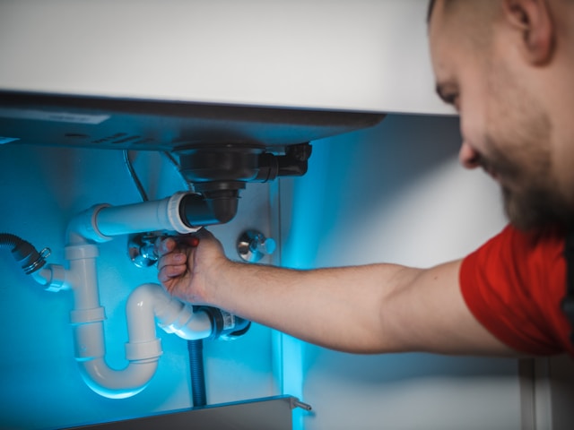 Emergency plumber fixing burst pipe